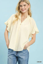 Cream-colored umgee textured ruffle sleeve blouse with ruffled short sleeves and subtle textured pattern