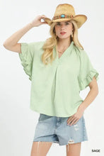 Light sage green Umgee textured ruffle sleeve blouse with short sleeves and a subtle textured pattern