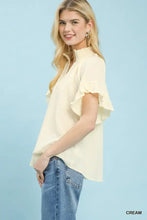Cream-colored umgee textured ruffle sleeve blouse with ruffled short sleeves and a high neckline for elegant wear