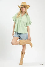 Light green umgee blouse with textured ruffle sleeve and v-neckline in soft textured fabric for stylish wear