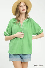 Apple green umgee textured split neck puff sleeve top with ruffled sleeves and white embroidery on neckline and cuffs