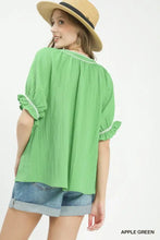 Apple green umgee textured split neck puff sleeve top with ruffled sleeves and white trim for stylish wear