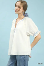 Cream-colored Umgee textured split neck puff sleeve top with delicate blue embroidery and soft fabric relaxed fit