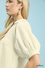 Off white umgee textured trim short sleeve blouse with puffed sleeves and subtle textured pattern
