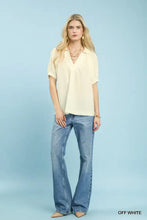 Off white umgee textured trim short sleeve blouse with v-neck and gathered sleeves featuring textured trim details