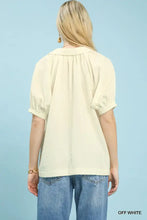 Off white short sleeve blouse with gathered neckline puffed sleeves and umgee textured trim detail for elegant wear