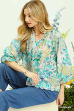 Umgee watercolor floral blouse featuring a flowing sheer fabric with teal and green floral pattern and flounce sleeves