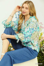 Umgee watercolor floral blouse with flounce sleeve in sheer fabric featuring vibrant blue and green floral pattern on white base