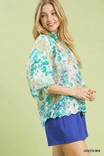Umgee watercolor floral blouse with flowing sheer fabric, vibrant green and white pattern, puffy sleeves, and scalloped hem
