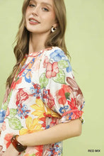 Umgee watercolor floral print top with high-low hem featuring vibrant reds blues yellows and greens on white background