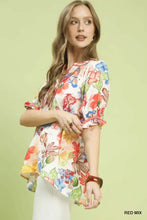 Umgee watercolor floral print blouse with short puffed sleeves and ruffled hem in bold reds blues yellows and greens