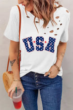 Woman in distressed USA graphic short sleeve round neck t-shirt and blue jeans