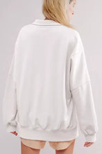 White oversized baggy sweatshirt with collared raw detail, ribbed cuffs, high low hem, slits, and machine wash care instructions