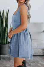 Light blue denim skater dress with fitted bodice flared skirt and V-back bow tie detail in denim skater style