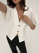 White satin v-neck button-down shirt with flutter sleeves and gold-toned neck buttons for elegant wear