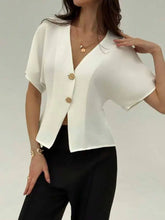 White satin short-sleeved blazer with v-neck button and gold-toned buttons in a stylish design
