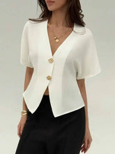White satin v-neck button-down shirt with short sleeves and gold-toned neck button detailing