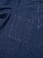 Dark blue long sleeve denim dress pocket with contrasting light stitching on v neck collared single chest pocket design