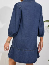 A women’s medium-wash long sleeve denim dress with a v neck collar, single chest pocket, puff sleeves, and flared hem