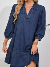 Navy blue long sleeve denim dress with collar, puff sleeves, and single chest pocket in denim material