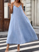A flowing light blue denim cami dress with v-neckline and frayed hem perfect for casual wear