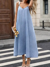 Light blue denim cami dress with thin straps and v-neckline made from soft denim fabric