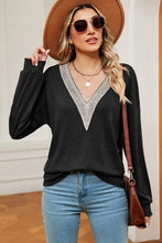 Womens long-sleeved black V-neck top with white lace trim, dropped shoulder