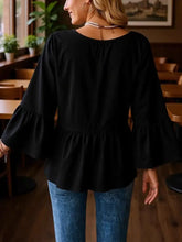Black v-neck flounce sleeve blouse with bell sleeves peplum hem and soft flowing fabric featuring neck flounce design