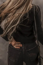 Woman in half button long sleeve t-shirt, viewed from behind