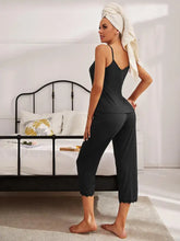Black v-neck lace trim camisole pajama top with adjustable strap length and scalloped hem with matching capri pants