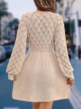 Back view of V-Neck Long Sleeve Sweater Dress in beige with textured leaf pattern