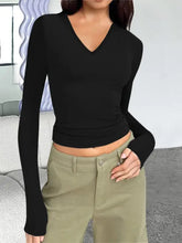 Black long sleeve V-neck crop top with moderate stretch