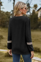 Black V-neck long sleeve blouse with embroidered cuffs