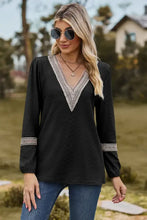 Black long sleeve V-neck blouse with white crochet trim