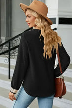 Black long sleeve V-neck waffle knit top with crochet cuffs