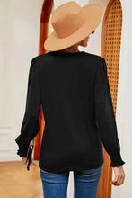 Women’s black V-neck long sleeve T-shirt with ruffled cuffs and wide-brimmed hat