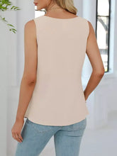Beige v-neck pleated tank with soft flowing fabric and sleeveless design featuring a rounded neckline
