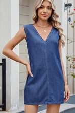 V-neck sleeveless denim dress in medium blue wash with front pockets made from durable denim fabric