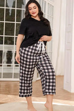Black and white checkered cropped pants with red heart accents and drawstring waistband paired with v neck tee sleeve length