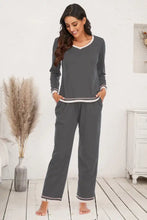 Gray v-neck top and pants lounge set with long sleeve length, white trim, and subtle striped accents for comfort