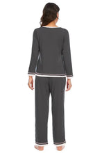 Dark gray v-neck top and pants lounge set with white trim and long sleeve length for comfortable wear