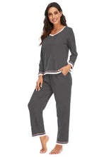 Gray v-neck top and pants lounge set with long sleeve length white trim and subtle striped accents