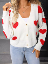 White slightly stretchy knit cardigan with Valentine’s Day heart pattern, gold buttons
