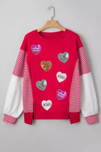 A vibrant red long-sleeved sweatshirt with striped sleeves and heart-shaped sequin patches for Valentines Day
