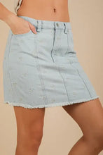 Light blue denim mini skirt with delicate white embroidered butterfly patterns and frayed hem from VERY J Bow Printed Casual denim mini skirt
