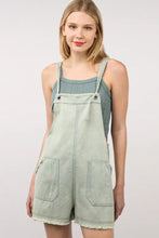 Woman in VERY J washed frayed hem denim overalls and tank top