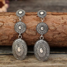 Vintage alloy dangle earrings with long silver concentric circular designs