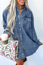 Blue denim dress with vintage wash featuring white buttons and a front pocket in a button-down style