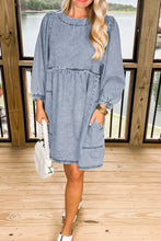 Light blue vintage wash denim dress with puffed sleeves tiered hemline and pockets in soft denim fabric