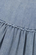 Light blue vintage wash denim dress featuring a skirt with frayed hem and subtle pleats with pockets